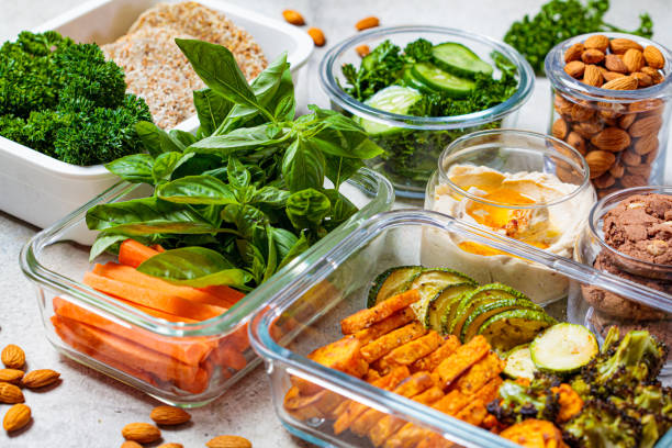Preparing healthy meals for the week. Vegan food and snacks in glass containers. stock photo