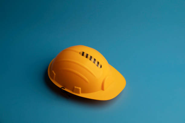 istock Yellow Safety helmet on blue background 1271088288