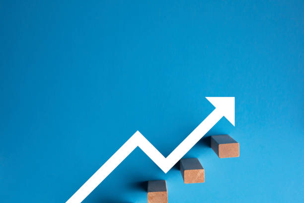 istock Wooden pegs placed in a stairway structure on blue background 1271088361