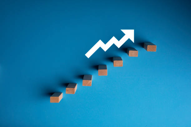 istock Wooden pegs placed in a stairway structure on blue background 1271088429