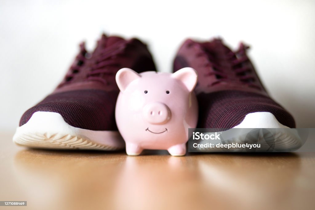 Piggybank in front of casual shoes Healthy Lifestyle Stock Photo