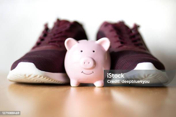 Piggybank In Front Of Casual Shoes Stock Photo - Download Image Now - Healthy Lifestyle, Finance, Piggy Bank