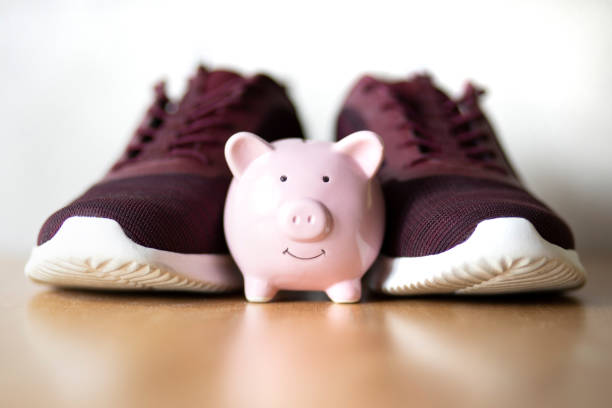 Piggybank in front of casual shoes