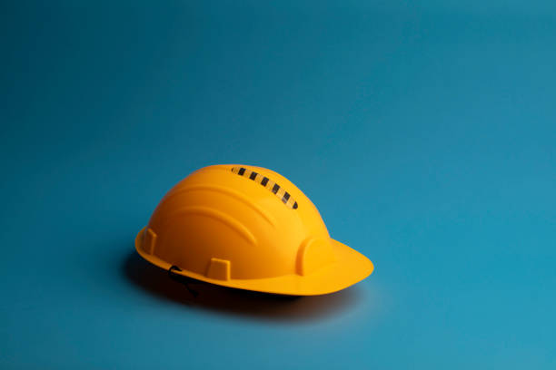 istock Yellow Safety helmet on blue background 1271088635