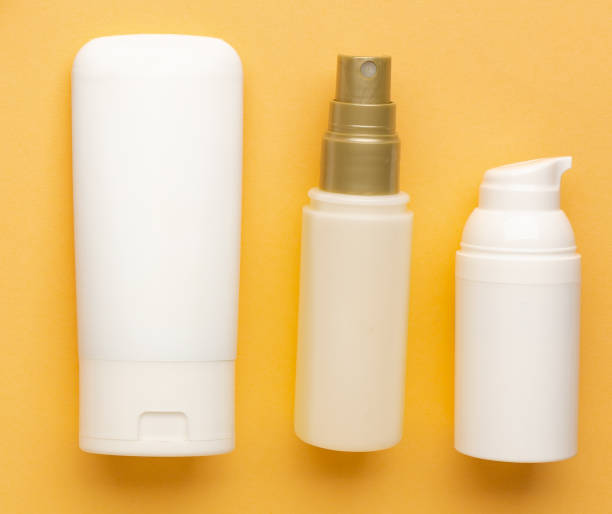 istock White blank cosmetic products bottles on orange background, as advertisement. 1271090300