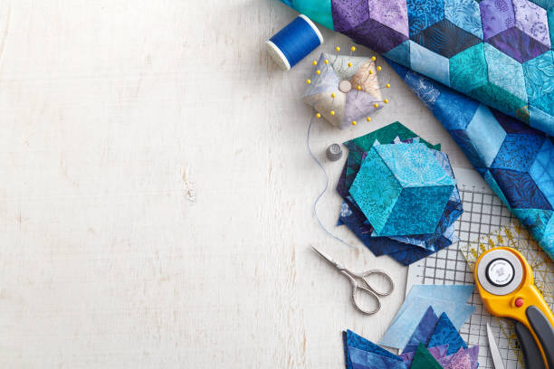 Fragment of tumbling blocks quilt, accessories for quilting on a white surface. Space for text. Fragment of tumbling blocks quilt, accessories for quilting on a white surface. Space for text. Stitch stock pictures, royalty-free photos & images