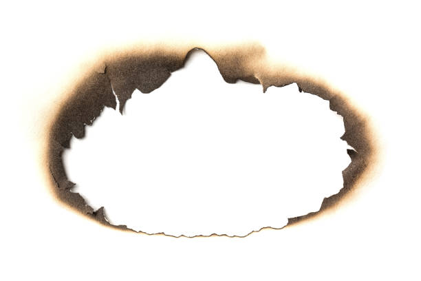 istock Fire burned hole white paper background texture. Paper burn mark stain 1271090945