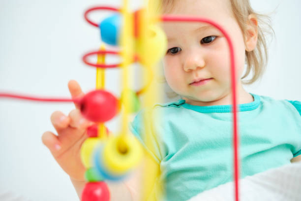 istock The toddler plays with his hands with learning toys. 1271091802