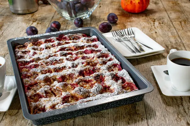 homemade german plum crumble cake on a baking sheet - warm and ready to eat
