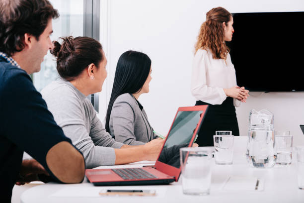 istock Group of office workers at a meeting around the boss 1271095480