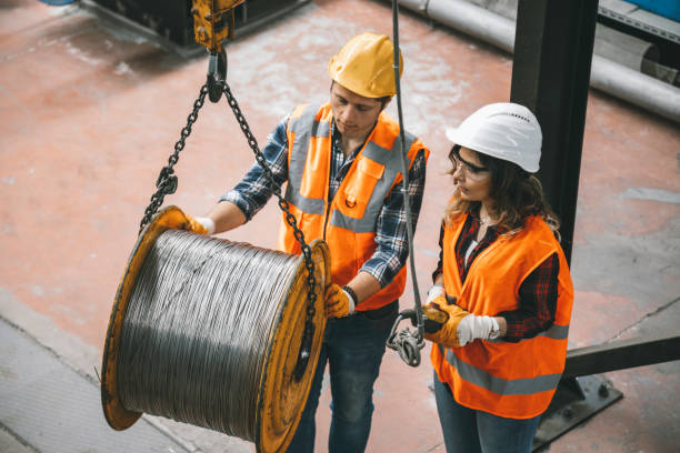 istock Young industry employees holding and working with remote control for operating crane 1271098684