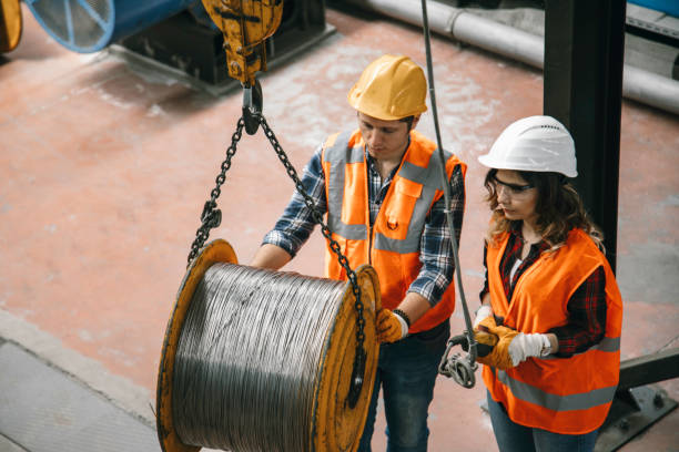 istock Young industry employees holding and working with remote control for operating crane 1271098804
