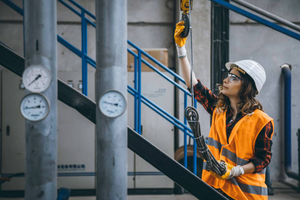 istock Young engineer woman holding and working with remote control for operating crane 1271099235