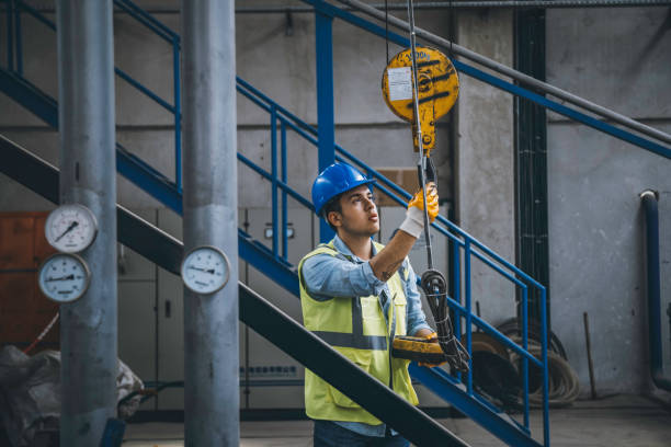 istock Young businessman holding and working with remote control for operating crane 1271099416