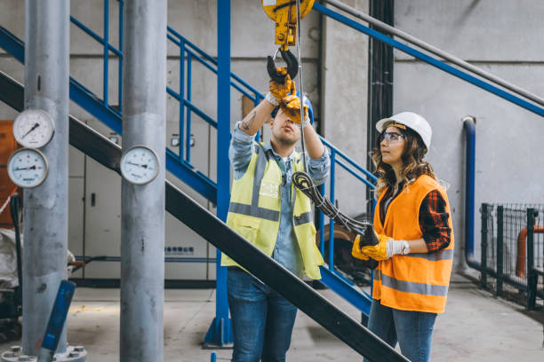 istock Young industry employees holding and working with remote control for operating crane 1271099472