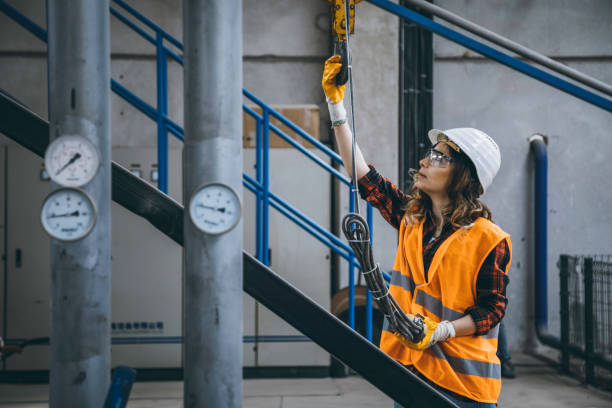 istock Young engineer woman holding and working with remote control for operating crane 1271100039