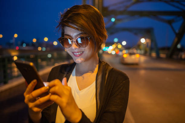istock asian lady smile with her mobile screen 1271100493