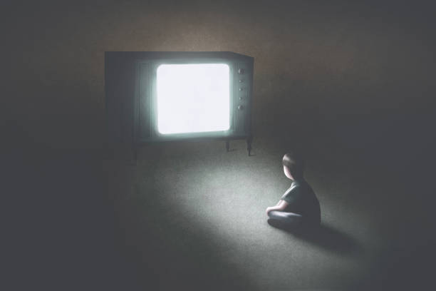 istock lonely kid watching tv in a dark room, education concept 1271102479