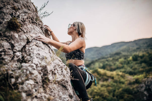 istock Female free climber climbing on the mountain 1271103173
