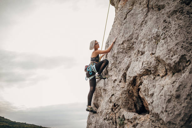 istock Female free climber climbing on the rock 1271103686