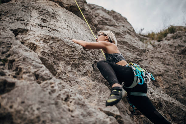 istock One female extreme climber climbing on the rock 1271104576
