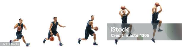 Young Basketball Player Against White Studio Background In Motion Of Steptostep Goal Stock Photo - Download Image Now