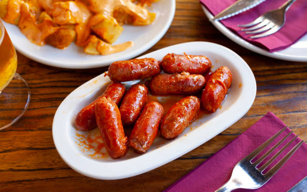 istock Spanish mini chorizo sausages at plate on table 1271105548