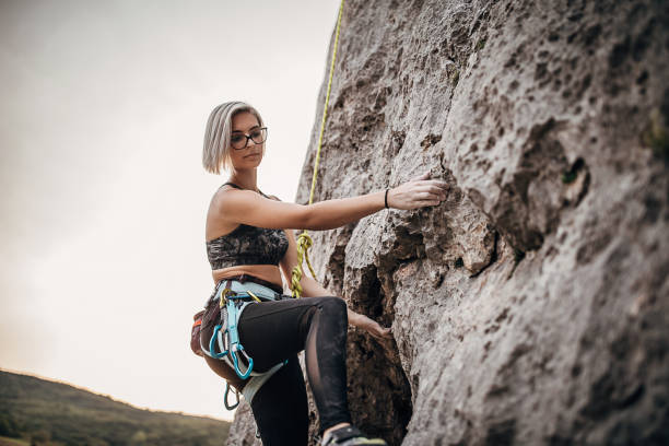 istock One woman free climber climbing on the rock 1271105551
