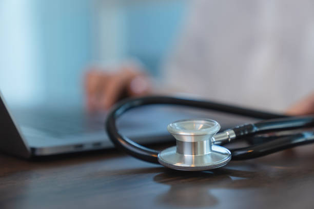istock The doctor using computer at the desk in office and the stethoscope on table. 1271106454