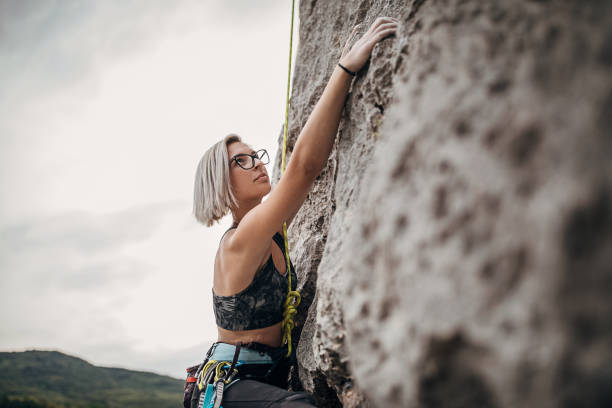 istock One young female extreme climber climbing on the rock 1271106699