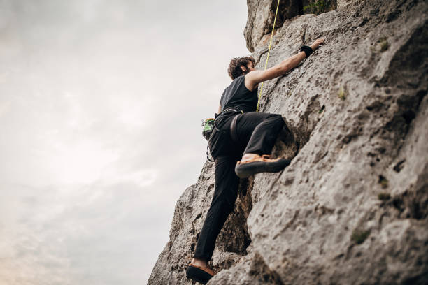 istock One young male free climber climbing on the rock 1271106937