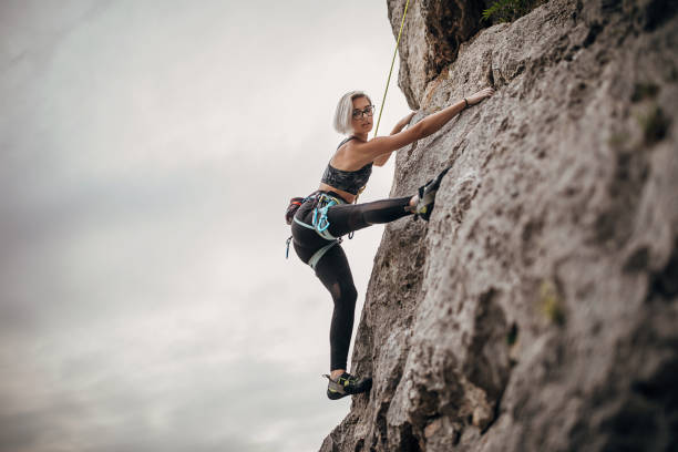 istock Woman extreme climber climbing on the rock 1271107679