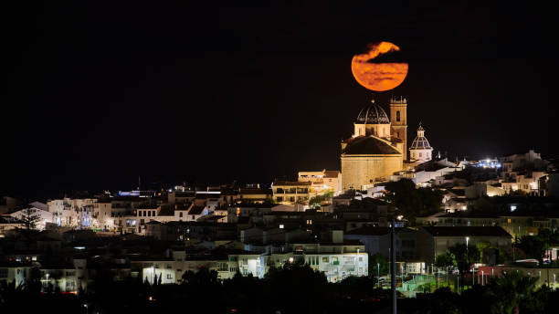 istock Full moon rise over town 1271108515