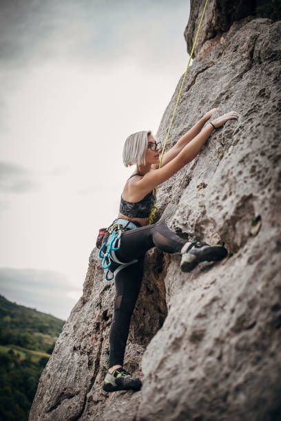 istock Young female extreme climber climbing on the rock 1271109139