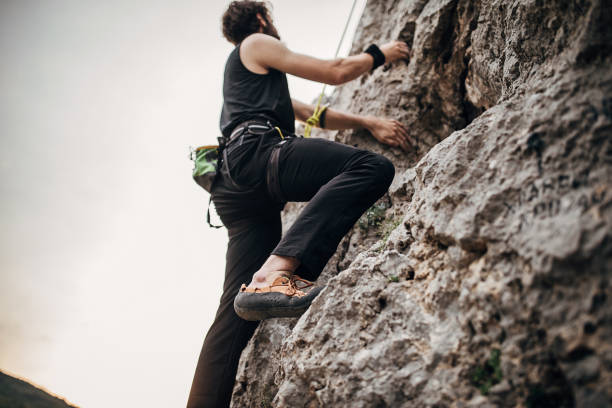 istock Young male free climber climbing on the rock 1271109596