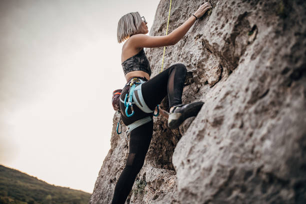 istock Young woman free climber climbing on the rock 1271110091