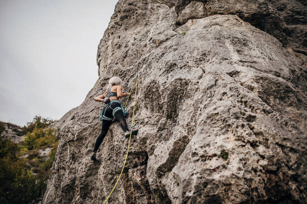 istock One female extreme climber climbing on the mountain 1271111913