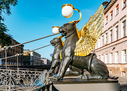 Bridge in Saint Petersburg ornate with Black lions statues with golden wings.