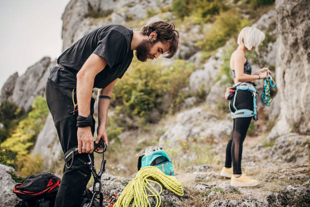 istock One young couple rock climbers preparing for climbing 1271112042
