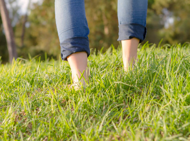 Barefoots woman walks. Relax and nature. Caucasican model