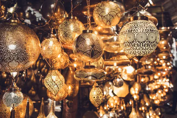 Photo of Traditional moroccan souvenir lamps on local market souk in Marrakesh medina. Handmade work, different shapes.