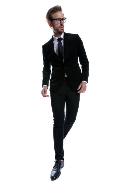 istock elegant young businessman in black suit looking to side 1271114077