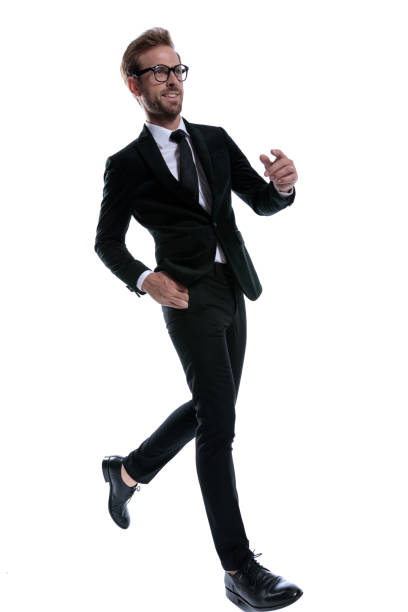 istock smiling elegant man in black suit marching 1271114180