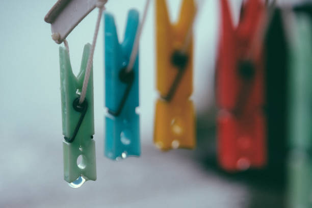 istock Coloured clothespins after a rain shower 1271115612