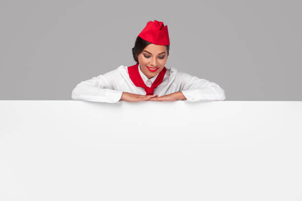 istock Happy stewardess looking at advertisement poster 1271115730