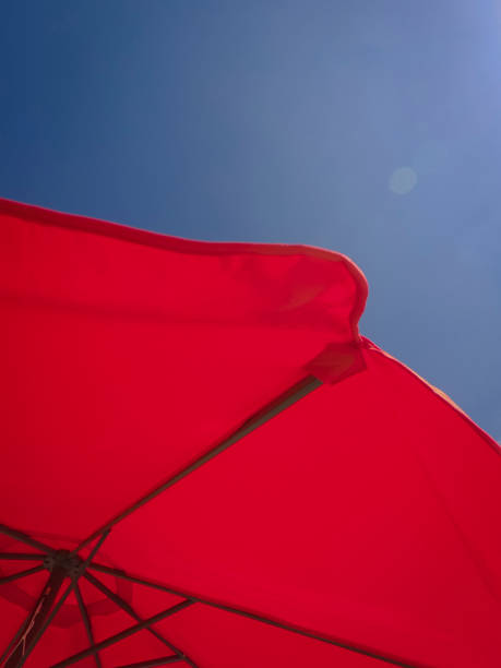 istock Red sun umbrella under sunny sky. 1271117994