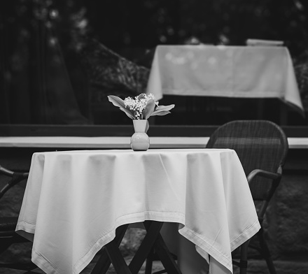 European street cafe. black and white photo of tables on a city street