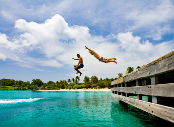 istock jumping off a dock into turquoise water in the caribbean 1271118612