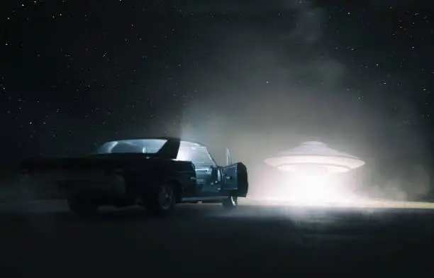 A UFO hovers over a desert, and an old car is parked in the foreground. Is someone getting abducted, or is someone hitching a ride?