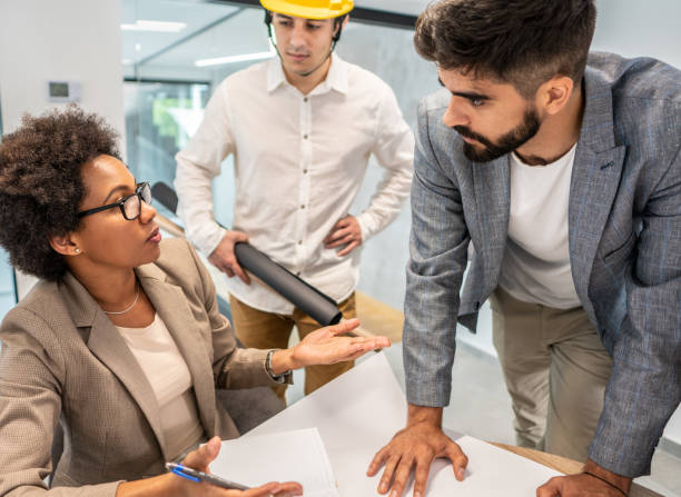 istock Colleagues sitting in a small group discussing something while working at an office 1271121560